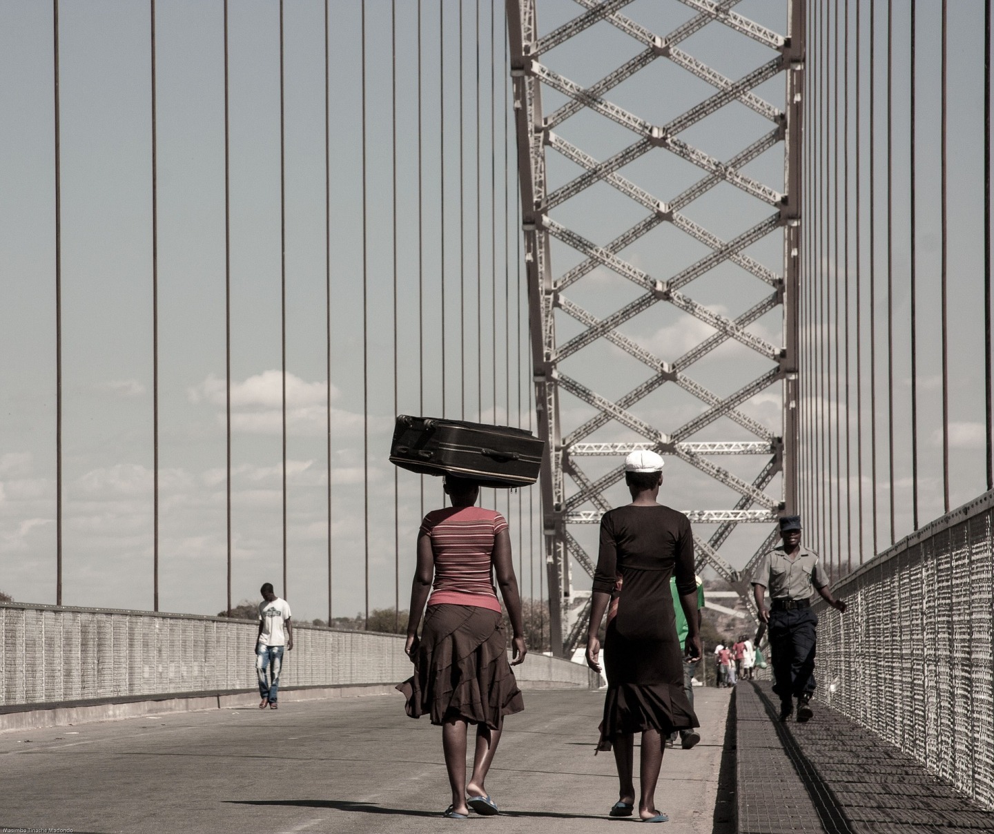 two african women walking across the bridge